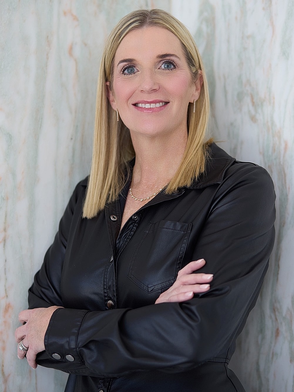 Woman in activewear with long, flowing hair.