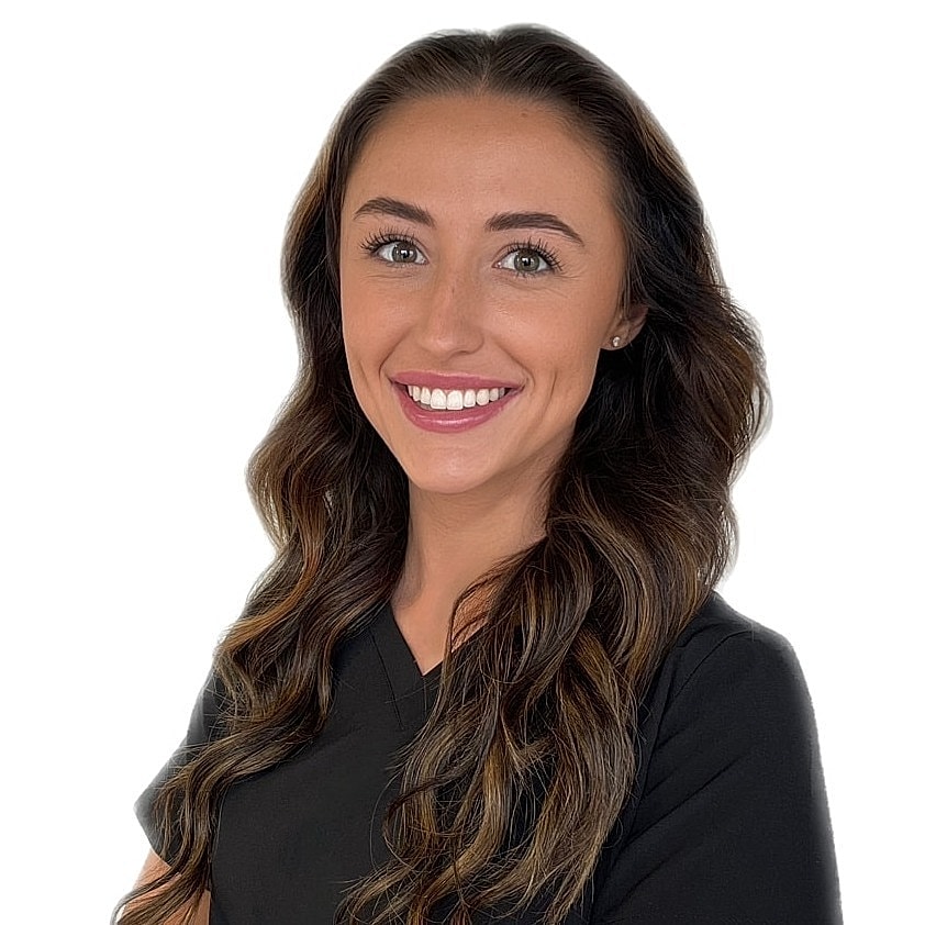 Smiling woman in black attire against white background.