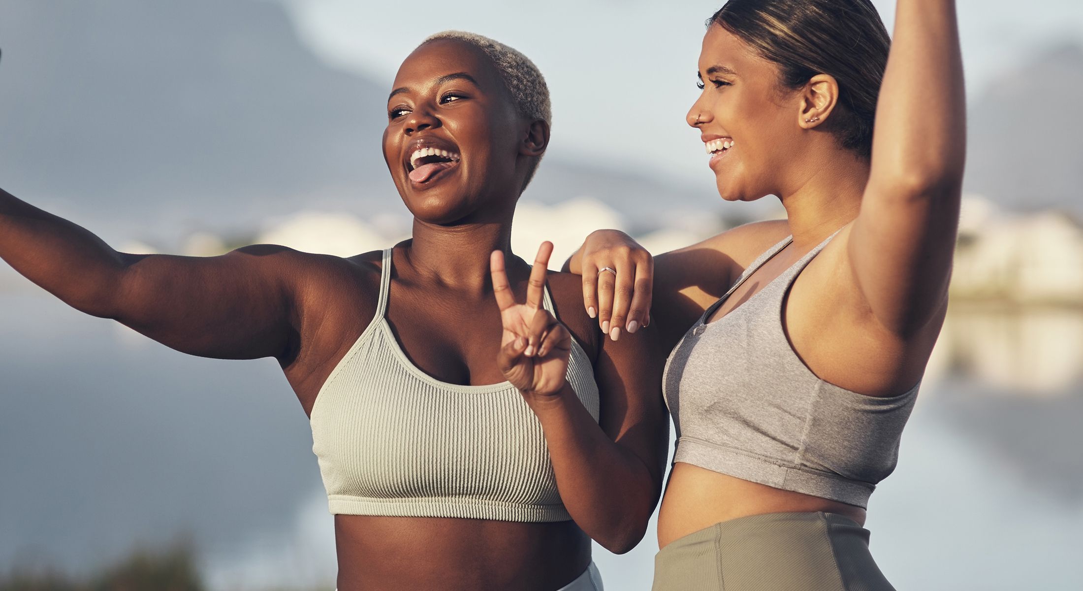 Two friends taking a joyful selfie outdoors.